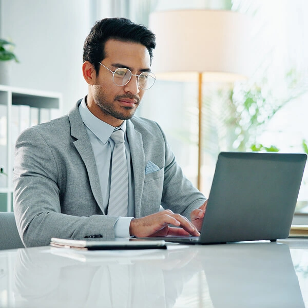 Financial professional working at a laptop